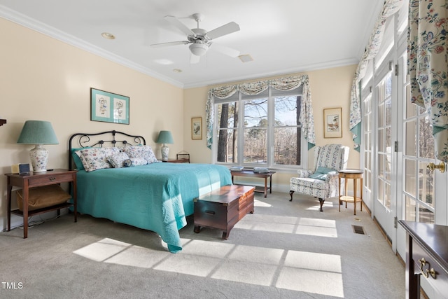 carpeted bedroom featuring ceiling fan and ornamental molding