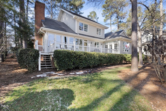 back of house featuring a yard and a wooden deck