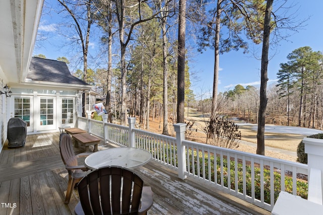 wooden terrace featuring french doors and a grill