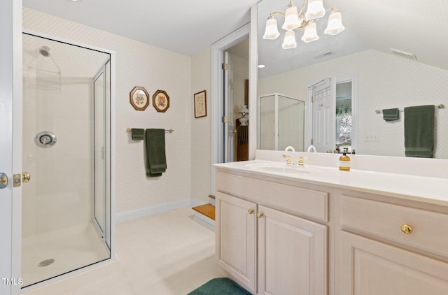 bathroom featuring a shower with door, a chandelier, vaulted ceiling, and vanity