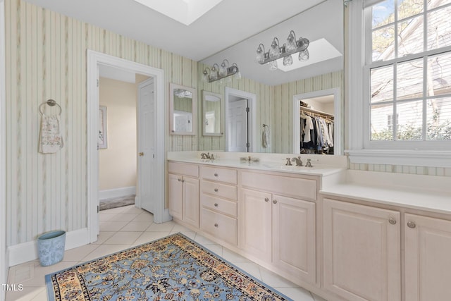 bathroom featuring vanity, tile patterned floors, and plenty of natural light