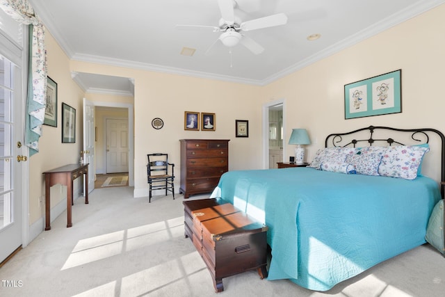 carpeted bedroom with ceiling fan and ornamental molding