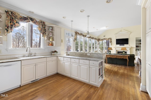 kitchen featuring sink, white cabinetry, dishwasher, and kitchen peninsula