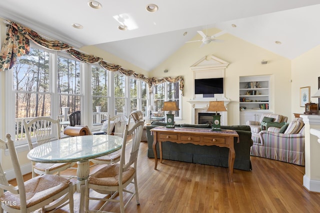 sunroom / solarium with lofted ceiling and ceiling fan