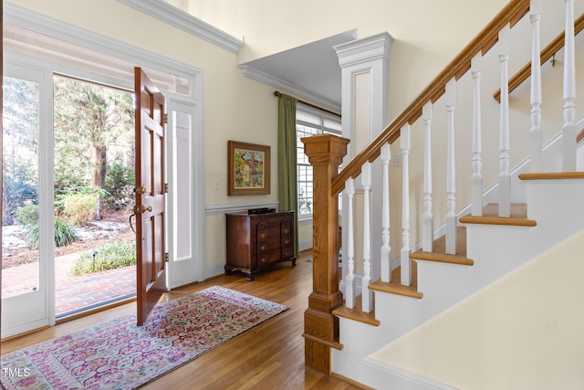 foyer entrance featuring hardwood / wood-style floors and ornamental molding