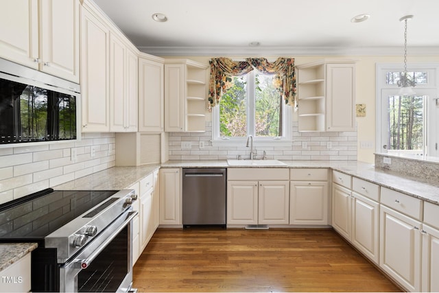 kitchen featuring plenty of natural light, a sink, stainless steel appliances, and open shelves