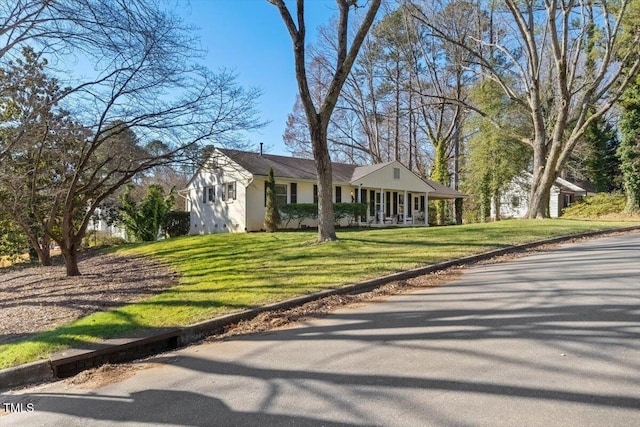 single story home featuring a porch and a front yard