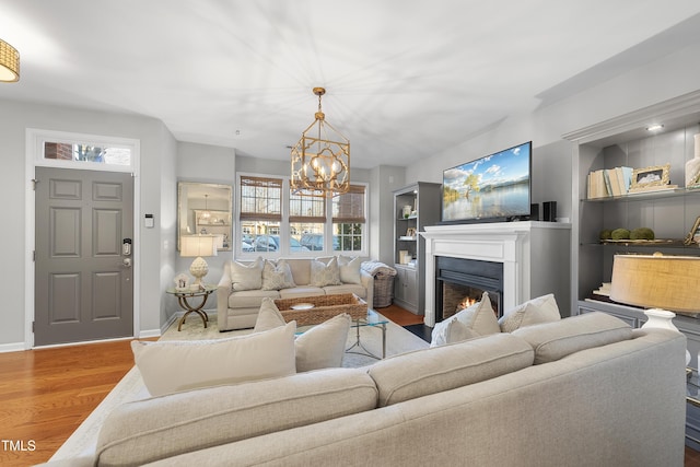 living room with a chandelier and light hardwood / wood-style flooring