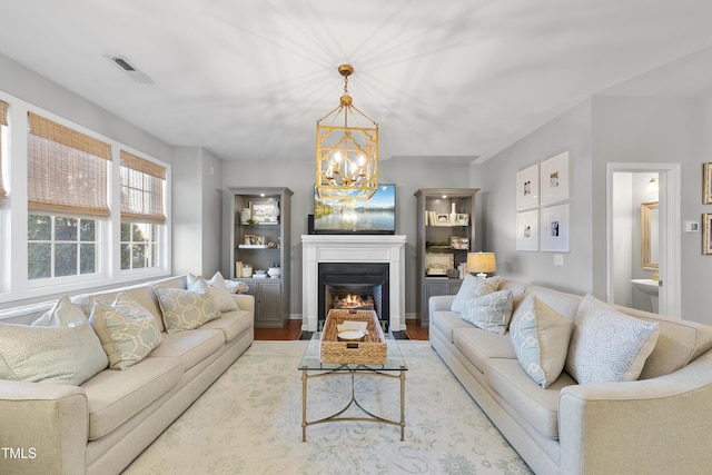 living room with a chandelier and light hardwood / wood-style floors