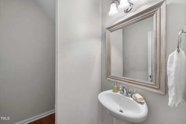 bathroom with hardwood / wood-style flooring and sink