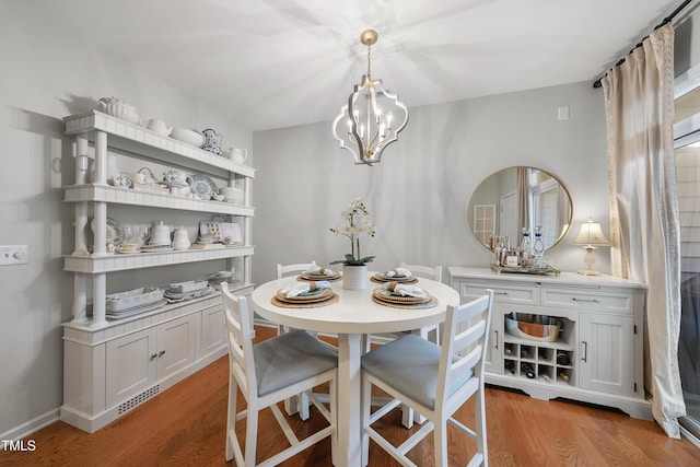 dining room featuring light hardwood / wood-style floors and an inviting chandelier