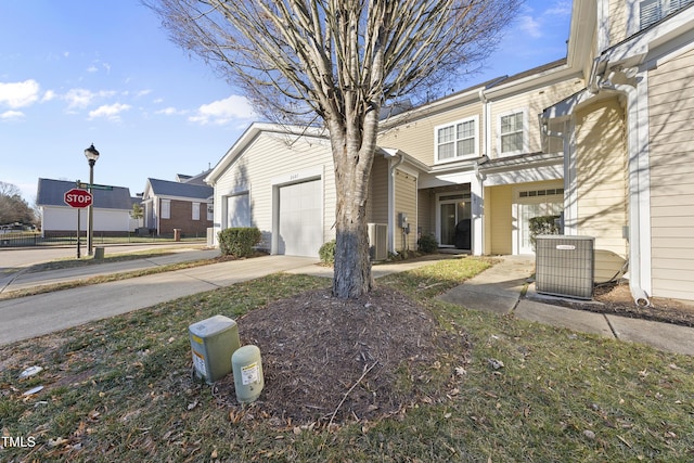 view of front of property with central AC and a garage