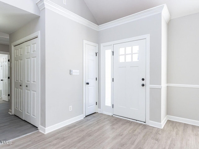 foyer featuring vaulted ceiling and light hardwood / wood-style flooring