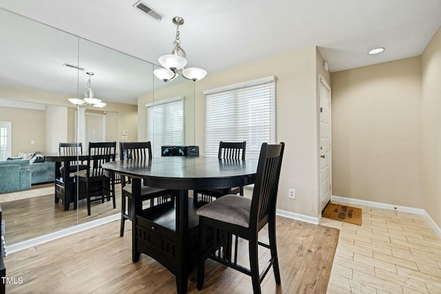 dining space featuring an inviting chandelier