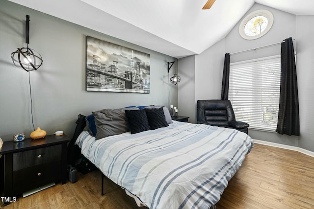 bedroom featuring ceiling fan, vaulted ceiling, and hardwood / wood-style floors