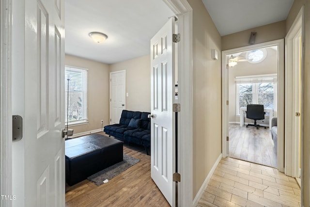 hallway with light hardwood / wood-style flooring