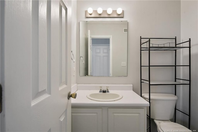 bathroom featuring toilet and vanity