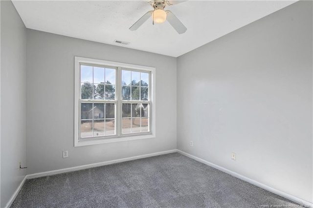 unfurnished room featuring ceiling fan and carpet