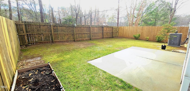 view of yard with central AC unit and a patio