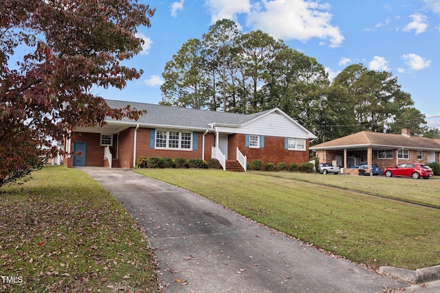 ranch-style house featuring a front lawn and a carport