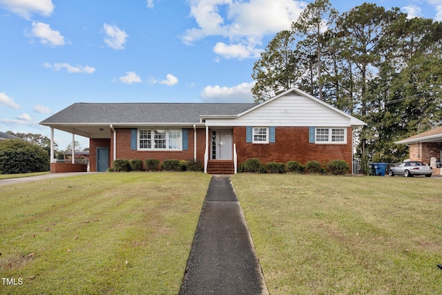 ranch-style home featuring a front lawn and a carport