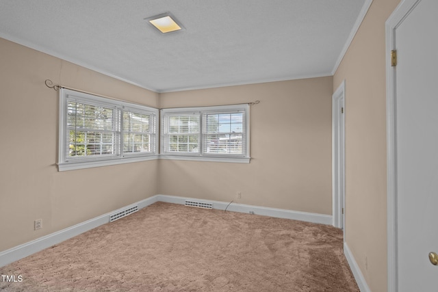 unfurnished room with a textured ceiling, ornamental molding, and carpet flooring