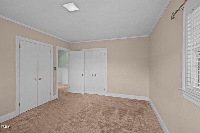 unfurnished bedroom with carpet and crown molding