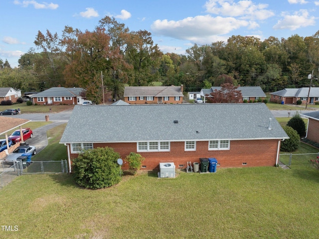 rear view of property featuring a lawn