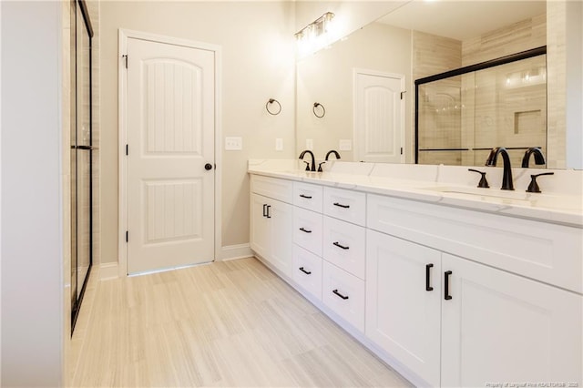 bathroom with walk in shower, vanity, and hardwood / wood-style floors