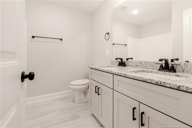 bathroom with toilet and vanity