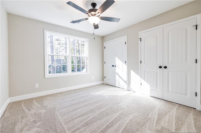 unfurnished bedroom featuring ceiling fan and light colored carpet