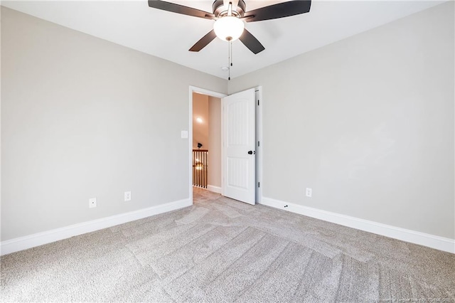 spare room featuring ceiling fan and light colored carpet