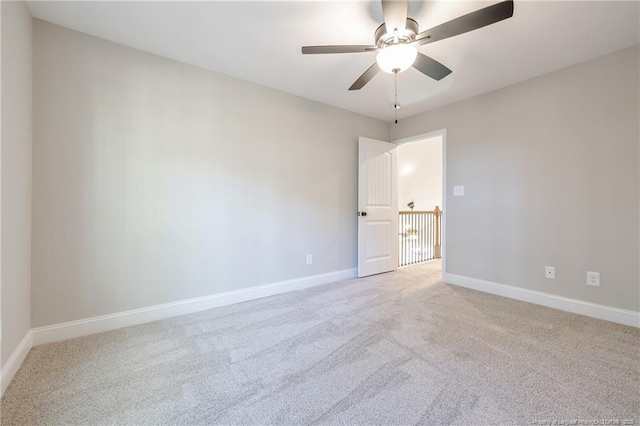 spare room featuring ceiling fan and light colored carpet