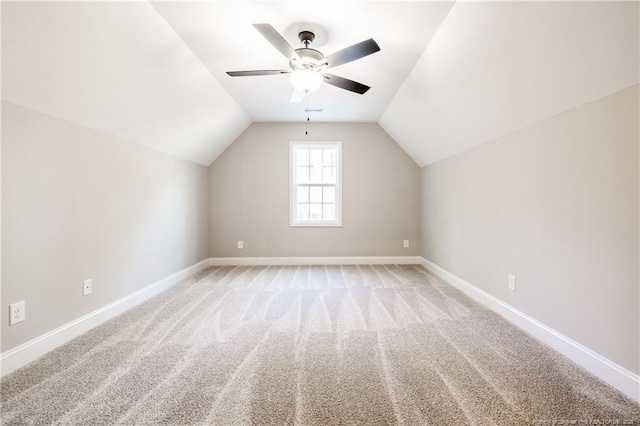 additional living space featuring lofted ceiling, ceiling fan, and light carpet