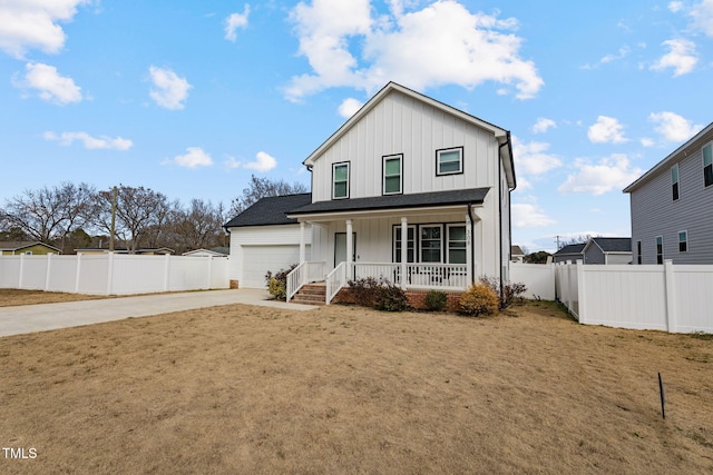 view of front facade featuring a front yard, a porch, and a garage