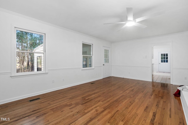 spare room with hardwood / wood-style flooring, ceiling fan, and ornamental molding