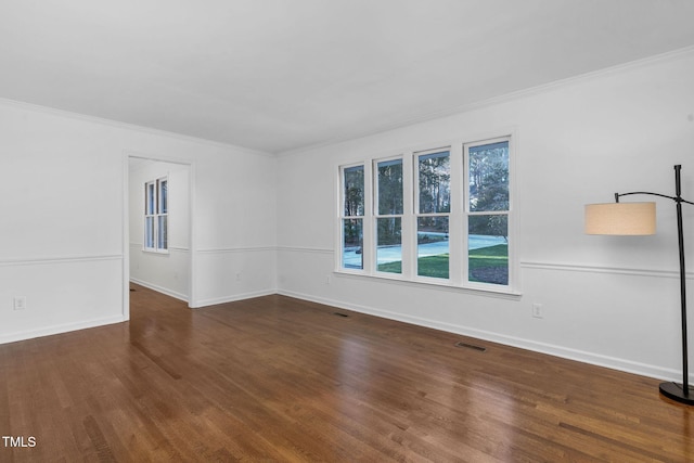 spare room with crown molding and dark hardwood / wood-style flooring