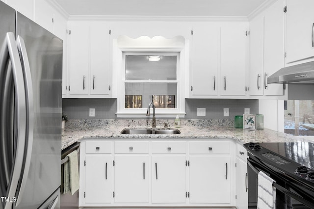 kitchen with sink, white cabinets, stainless steel fridge, light stone countertops, and black / electric stove