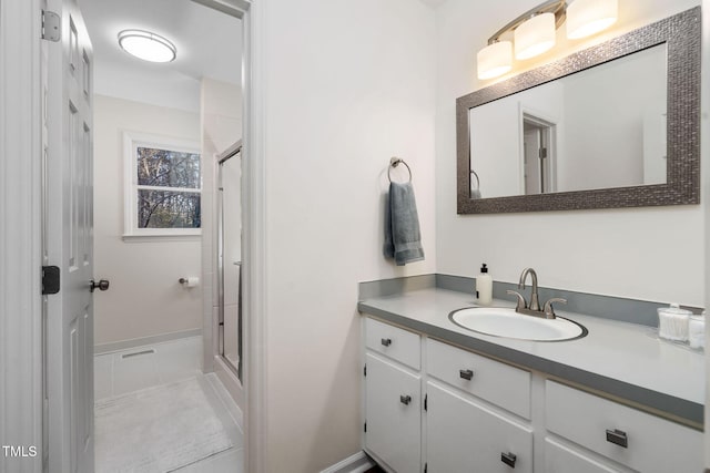 bathroom featuring vanity, a shower with shower door, and tile patterned flooring