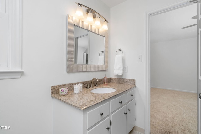 bathroom with ceiling fan and vanity