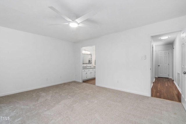 spare room featuring sink, ceiling fan, and carpet flooring