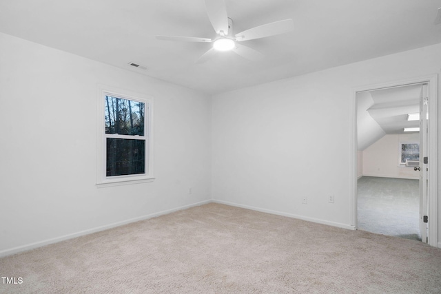 unfurnished room featuring ceiling fan, lofted ceiling, and carpet floors