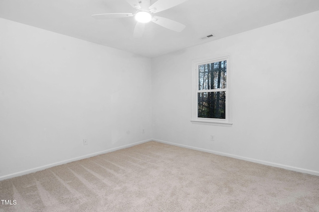 carpeted spare room with ceiling fan