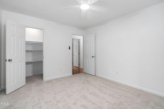 unfurnished bedroom with light colored carpet, a closet, and ceiling fan