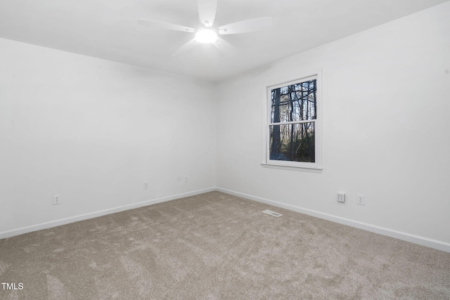 spare room featuring ceiling fan and carpet