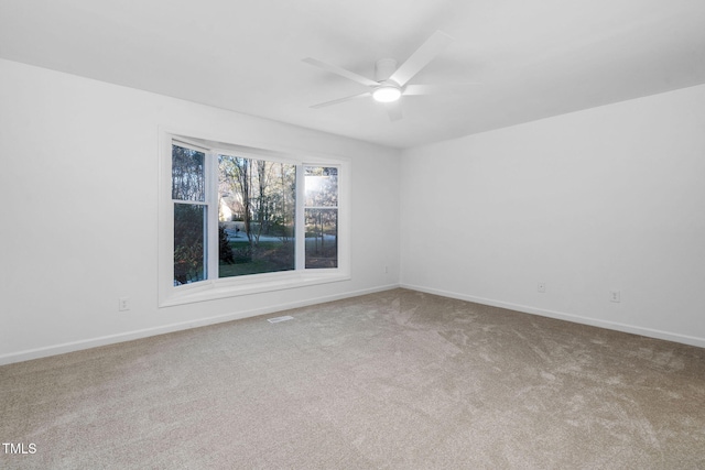 spare room with ceiling fan and carpet flooring