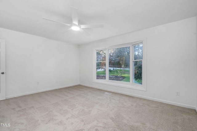 carpeted empty room featuring ceiling fan