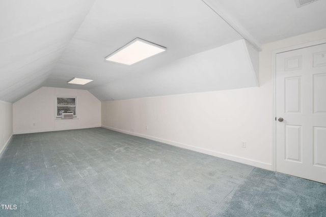 additional living space featuring lofted ceiling and carpet