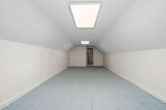 bonus room featuring vaulted ceiling and light colored carpet