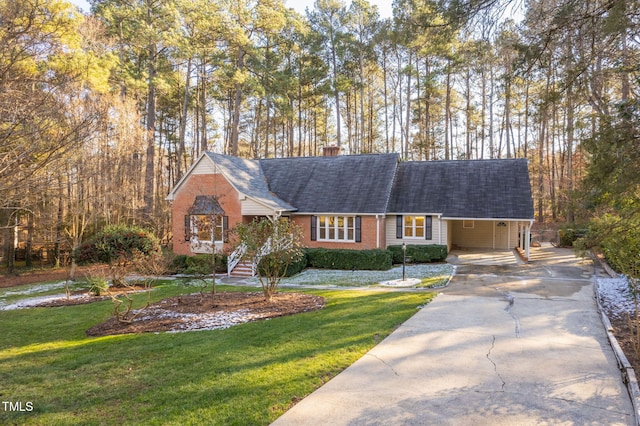 view of front of home with a front yard and a carport